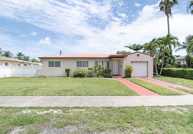 view of front of house with a front yard and a garage