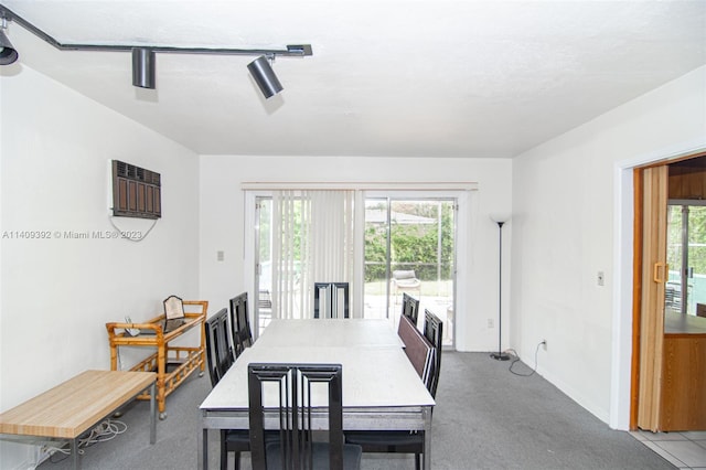 dining space featuring track lighting and a wall unit AC