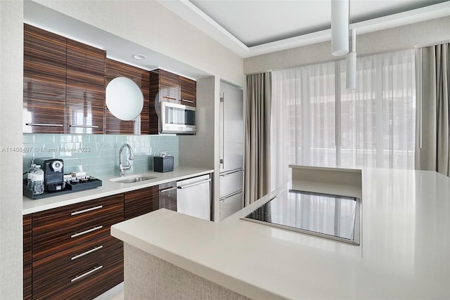 kitchen featuring dishwashing machine, backsplash, stainless steel microwave, and sink