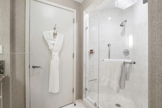 bathroom with a shower with door