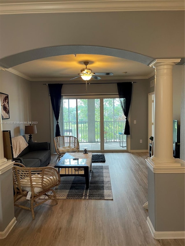 living room with ornamental molding, decorative columns, ceiling fan, and hardwood / wood-style flooring