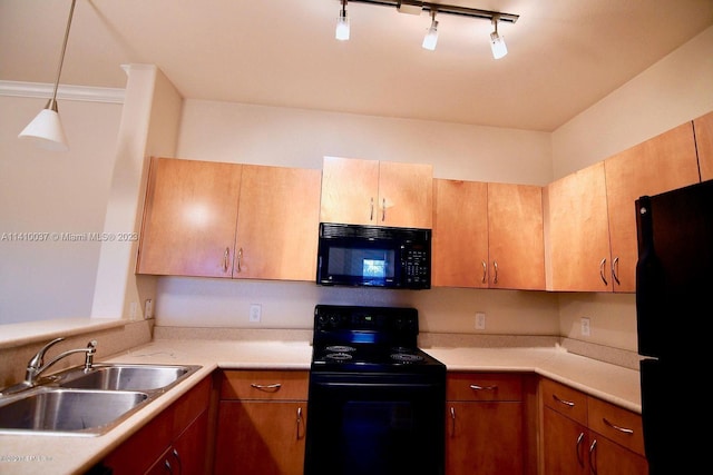 kitchen with hanging light fixtures, rail lighting, black appliances, and sink