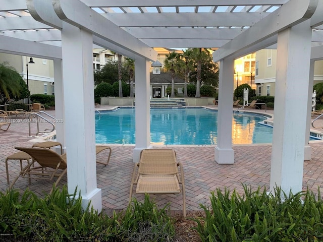 view of swimming pool with a patio and a pergola