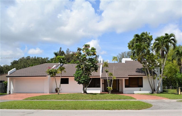 single story home with a front lawn and a garage