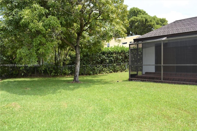 view of yard featuring a sunroom