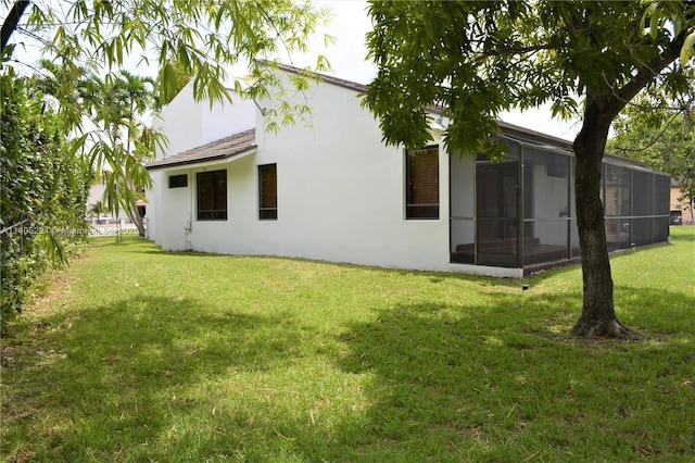 rear view of property featuring a lawn