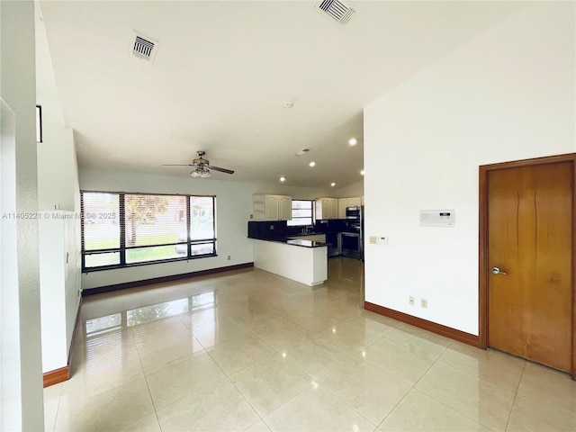 unfurnished living room featuring ceiling fan and light tile patterned flooring