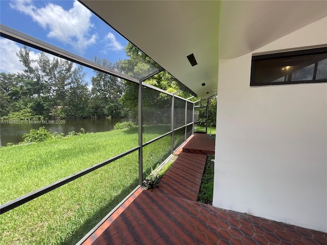 unfurnished sunroom featuring a water view