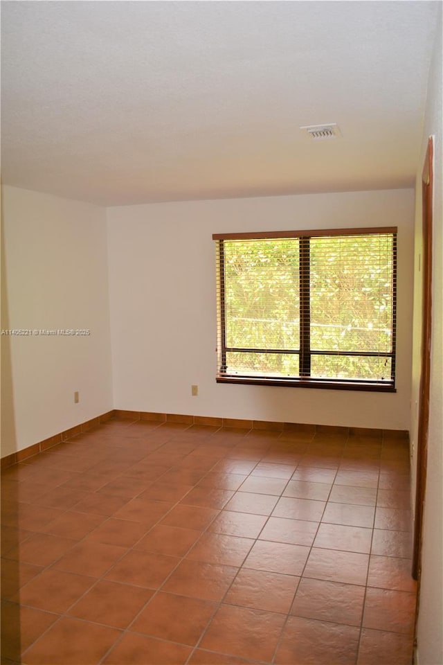 empty room with tile patterned floors