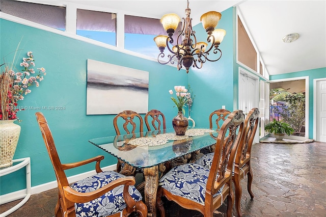 dining space with a notable chandelier and vaulted ceiling