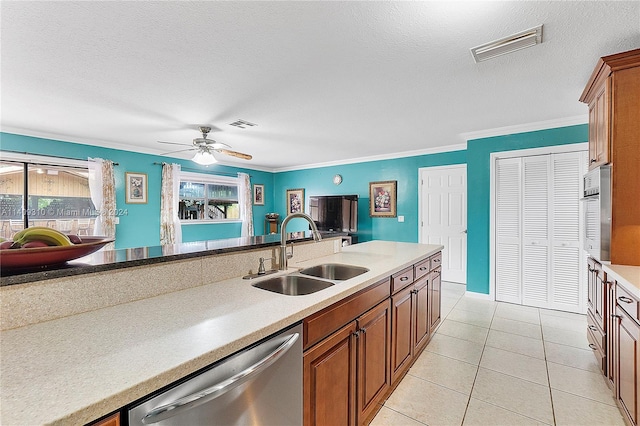 kitchen with sink, light tile patterned floors, crown molding, dishwasher, and ceiling fan