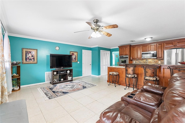 living room featuring light tile patterned flooring, ceiling fan, and ornamental molding