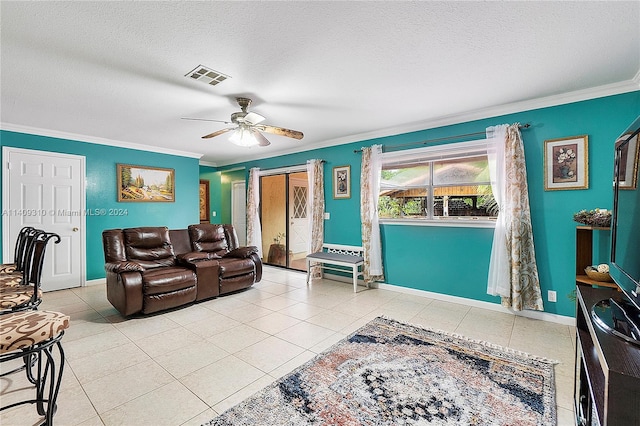 living room with ornamental molding, light tile patterned floors, a textured ceiling, and ceiling fan