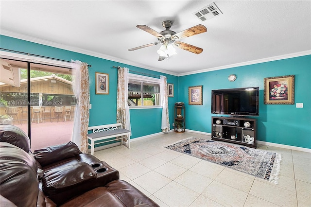 living room featuring ornamental molding, light tile patterned floors, and ceiling fan