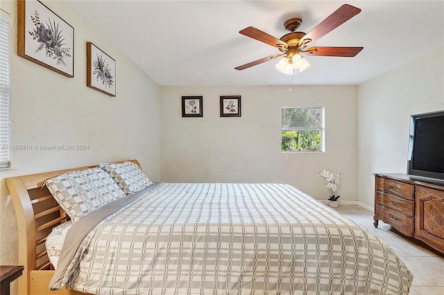 bedroom featuring ceiling fan, light tile patterned flooring, and baseboards