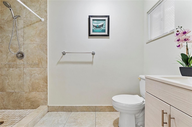 full bathroom featuring toilet, a stall shower, tile patterned flooring, and vanity