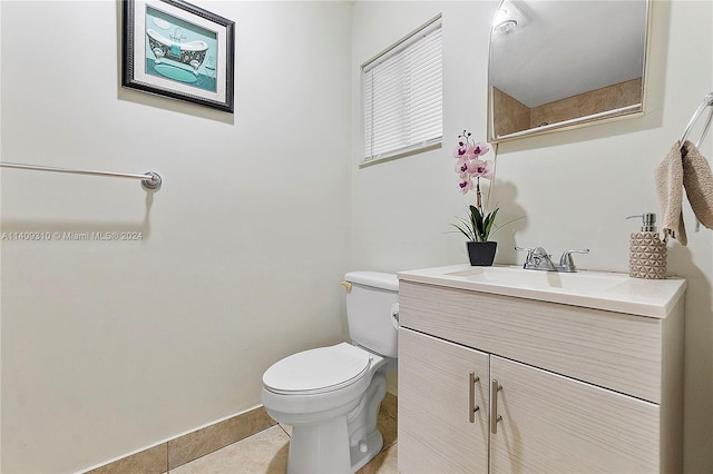 bathroom with vanity, tile patterned flooring, and toilet