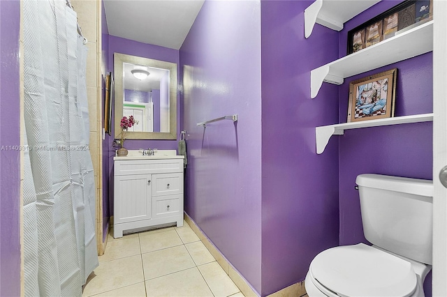 bathroom featuring vanity, toilet, and tile patterned floors