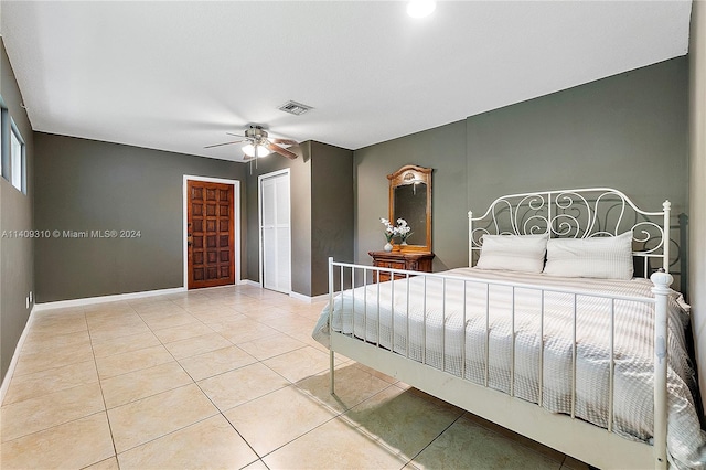 tiled bedroom with ceiling fan