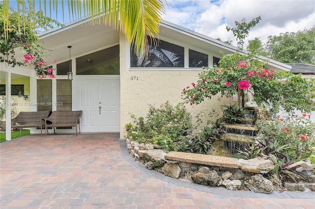 doorway to property with stucco siding