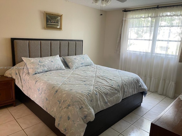 tiled bedroom with ceiling fan