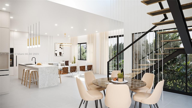 dining area featuring sink, a wealth of natural light, and light tile flooring