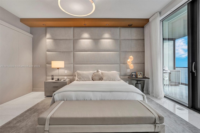 bedroom featuring floor to ceiling windows, access to outside, and light tile floors