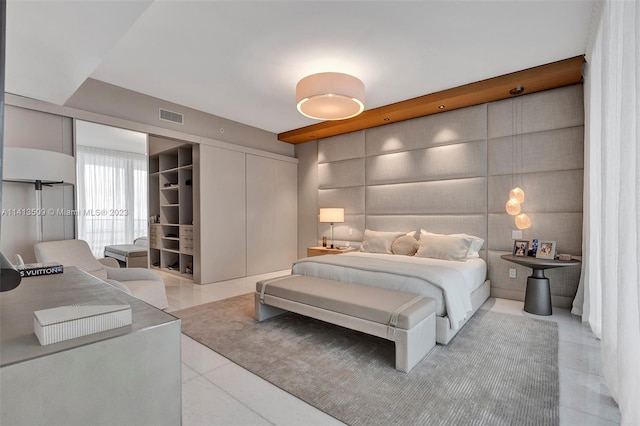 tiled bedroom featuring a closet