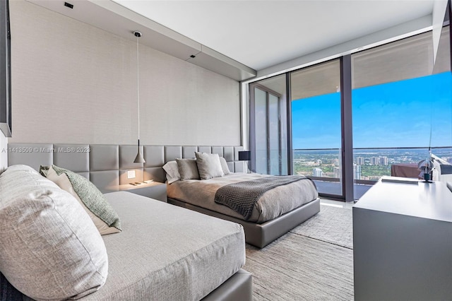 bedroom featuring access to outside and expansive windows