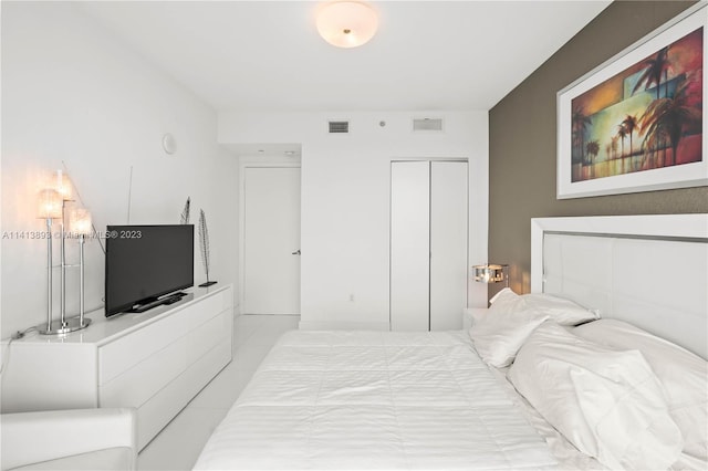 tiled bedroom with a closet