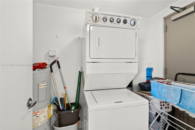 washroom featuring stacked washer and dryer and electric water heater