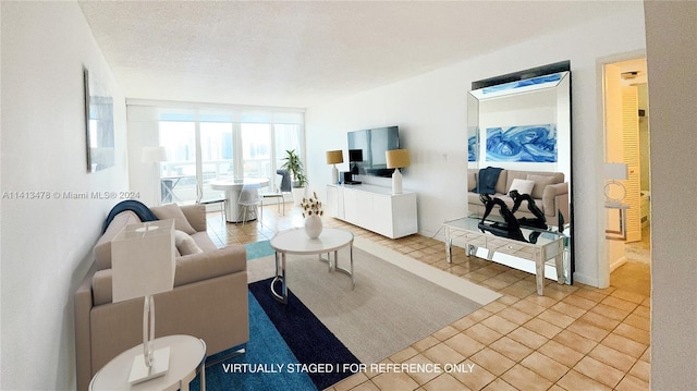 tiled living room featuring a textured ceiling and a wall of windows