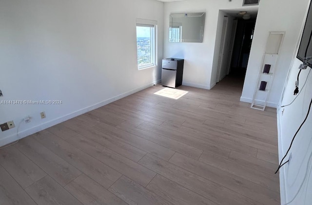 unfurnished room featuring hardwood / wood-style flooring