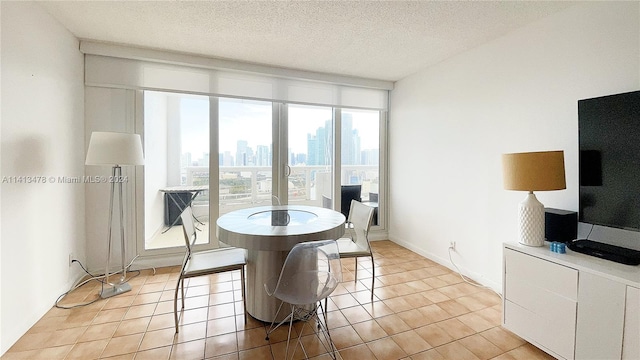 dining room featuring a textured ceiling and light tile flooring