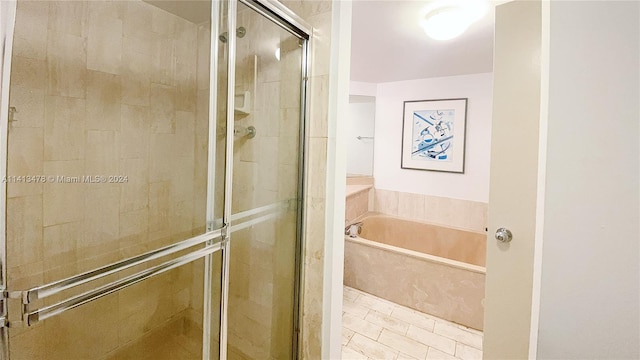 bathroom featuring tile floors and independent shower and bath