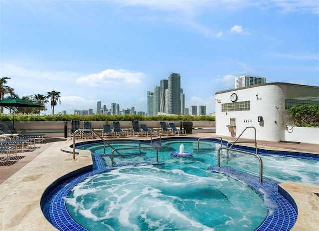 view of pool featuring a community hot tub and pool water feature