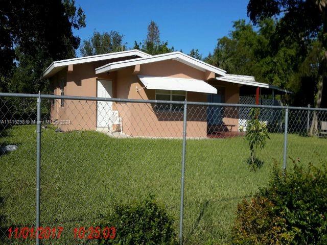 view of side of property with a yard