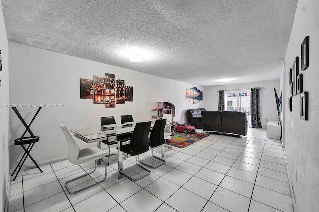 dining space featuring light tile floors and a textured ceiling