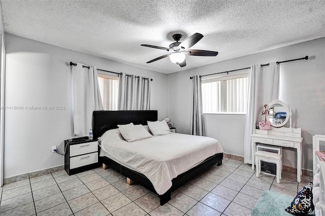 tiled bedroom featuring ceiling fan and a textured ceiling