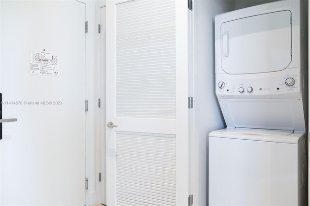 washroom featuring stacked washer / drying machine