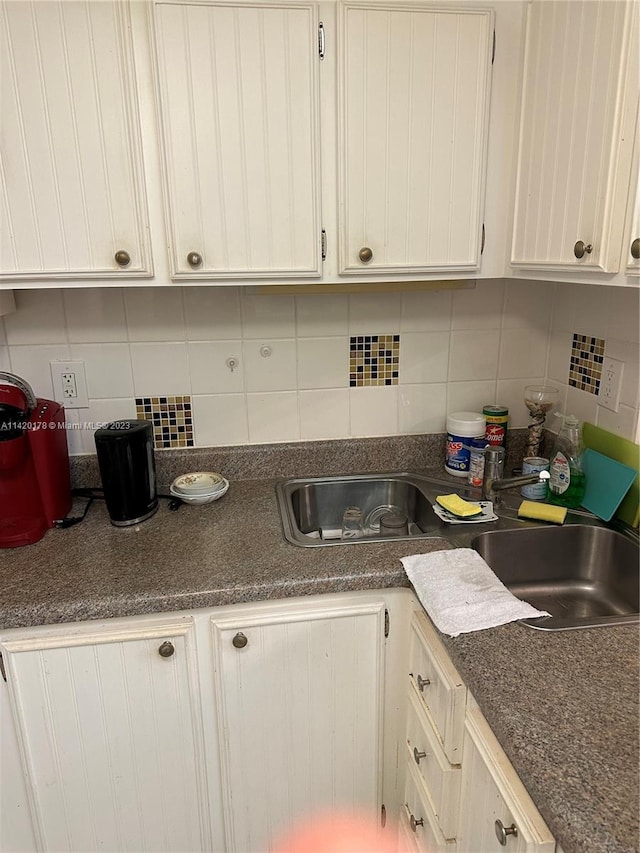 kitchen with white cabinets and tasteful backsplash