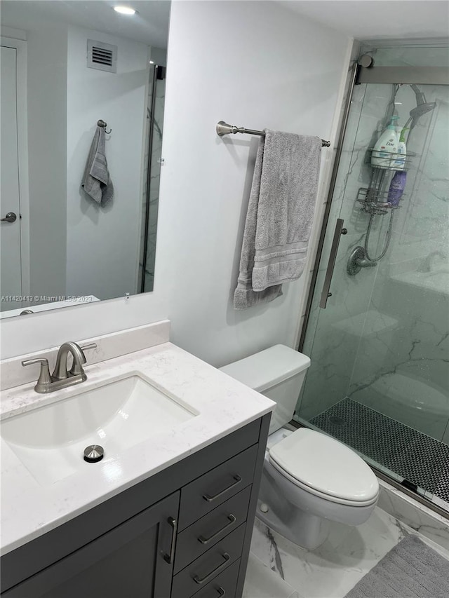 bathroom with vanity, tile flooring, toilet, and walk in shower