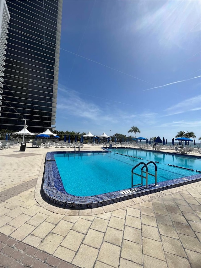 view of swimming pool featuring a patio area