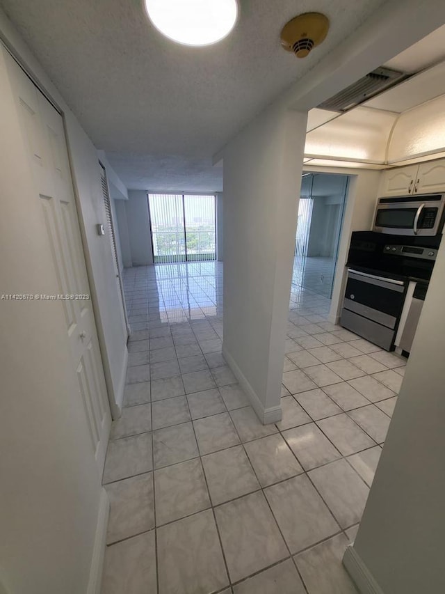 hall with light tile floors