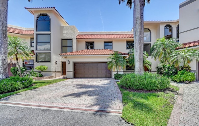 mediterranean / spanish house with a garage