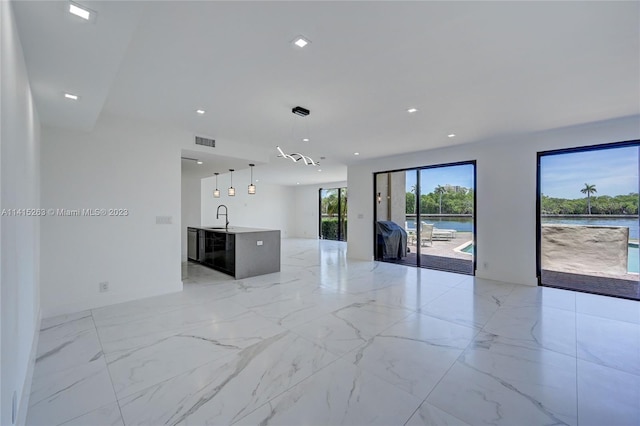 empty room with sink and light tile floors