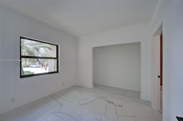 unfurnished room with light tile flooring