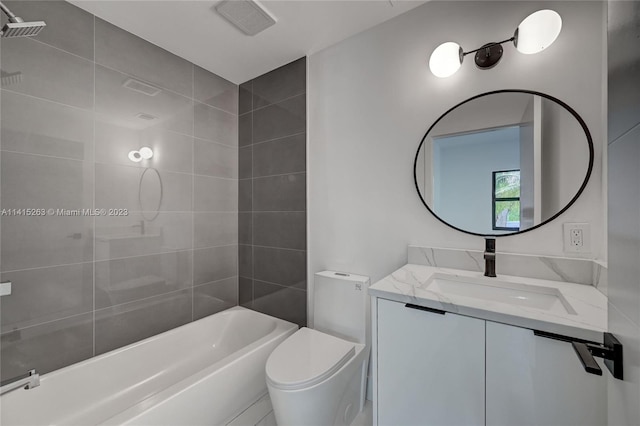 full bathroom featuring tiled shower / bath, vanity, and toilet