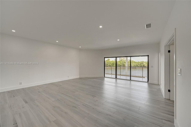 spare room featuring light wood-type flooring