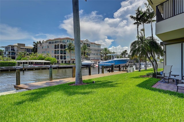 view of dock featuring a water view and a yard